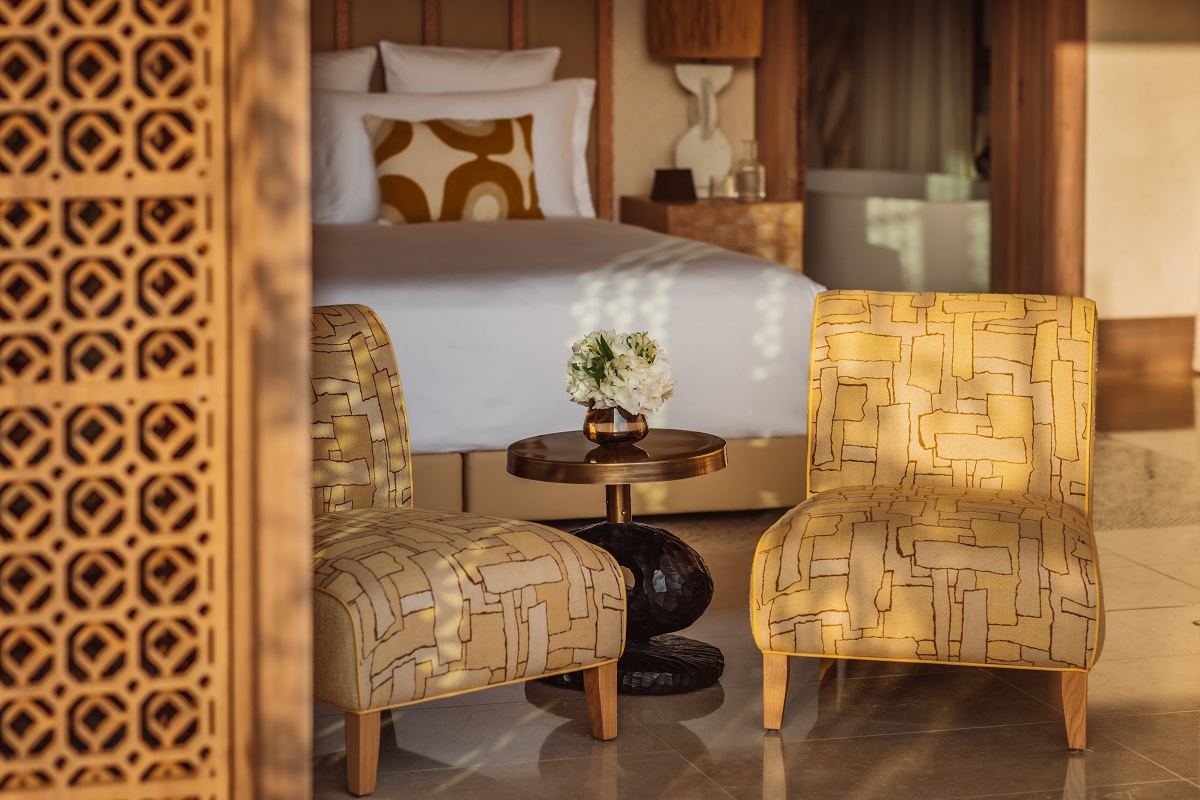 carved wooden screen, chairs and bed in royal mansour tamuda bay