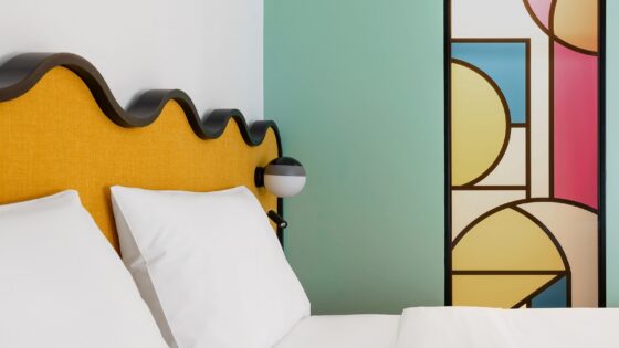 yellow wavy headboard detail and painted mural in guestroom by Studio Shoo in ibis Tiblisi