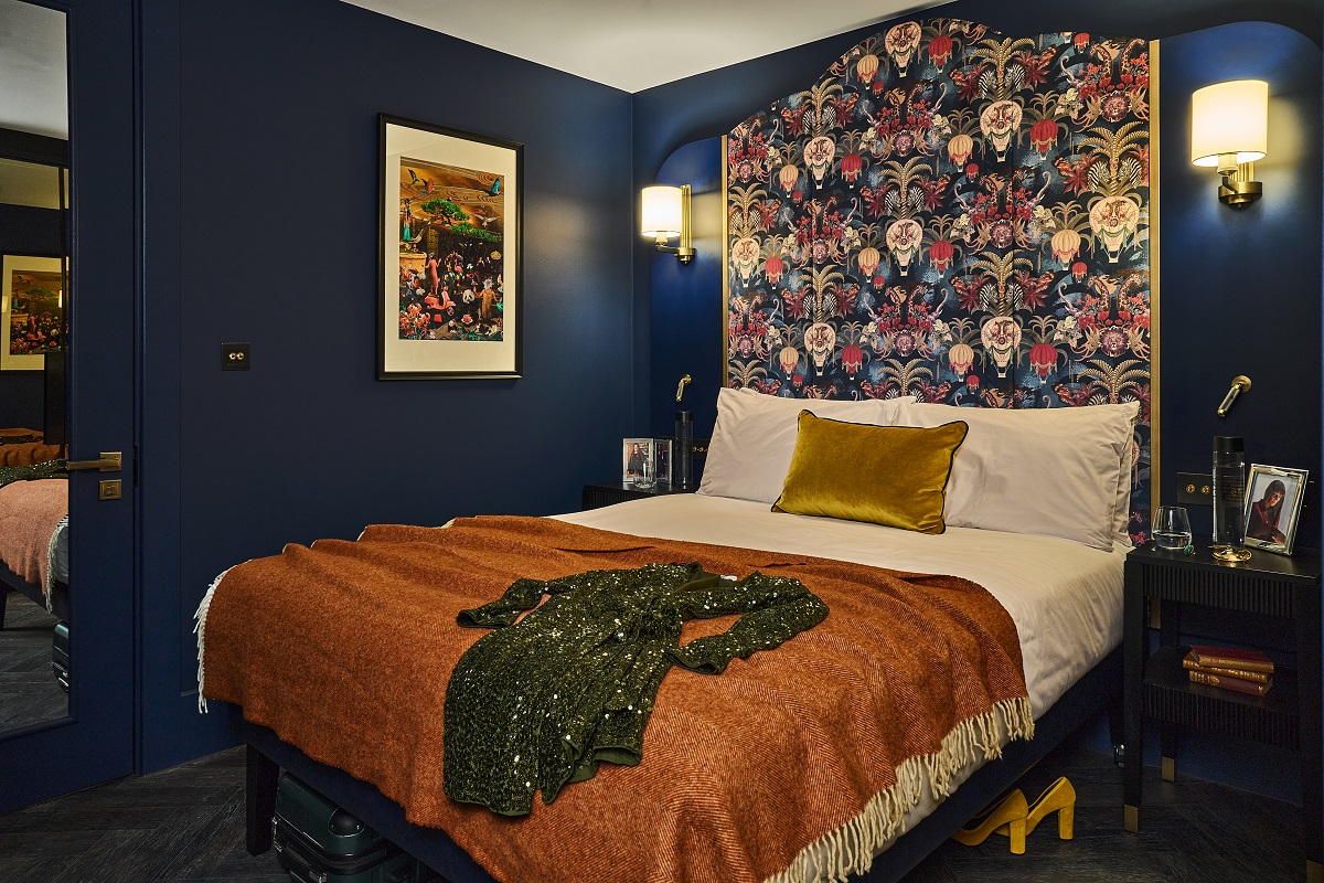 Dark blue bedroom interior with gold accents