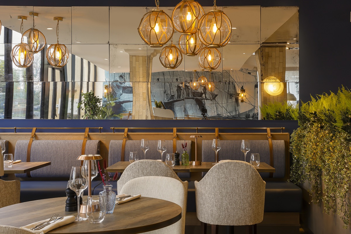 view across restaurant in voco Southampton with mural reflected in mirror