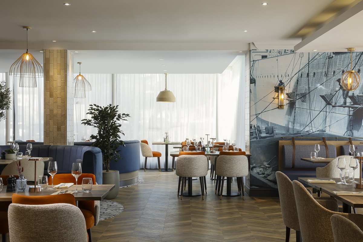 cream, blue and orange seating in voco restaurant