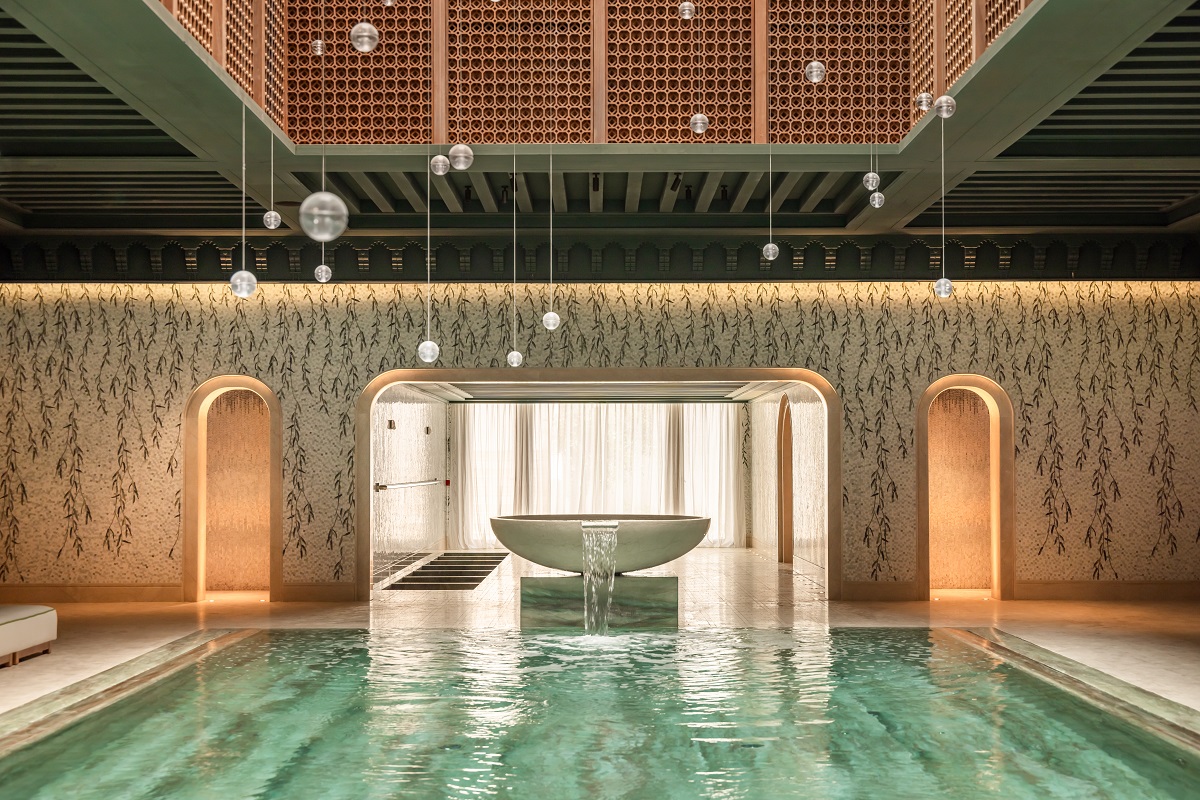 suspended lights, wter feature and leaf patterned tiles in the spa