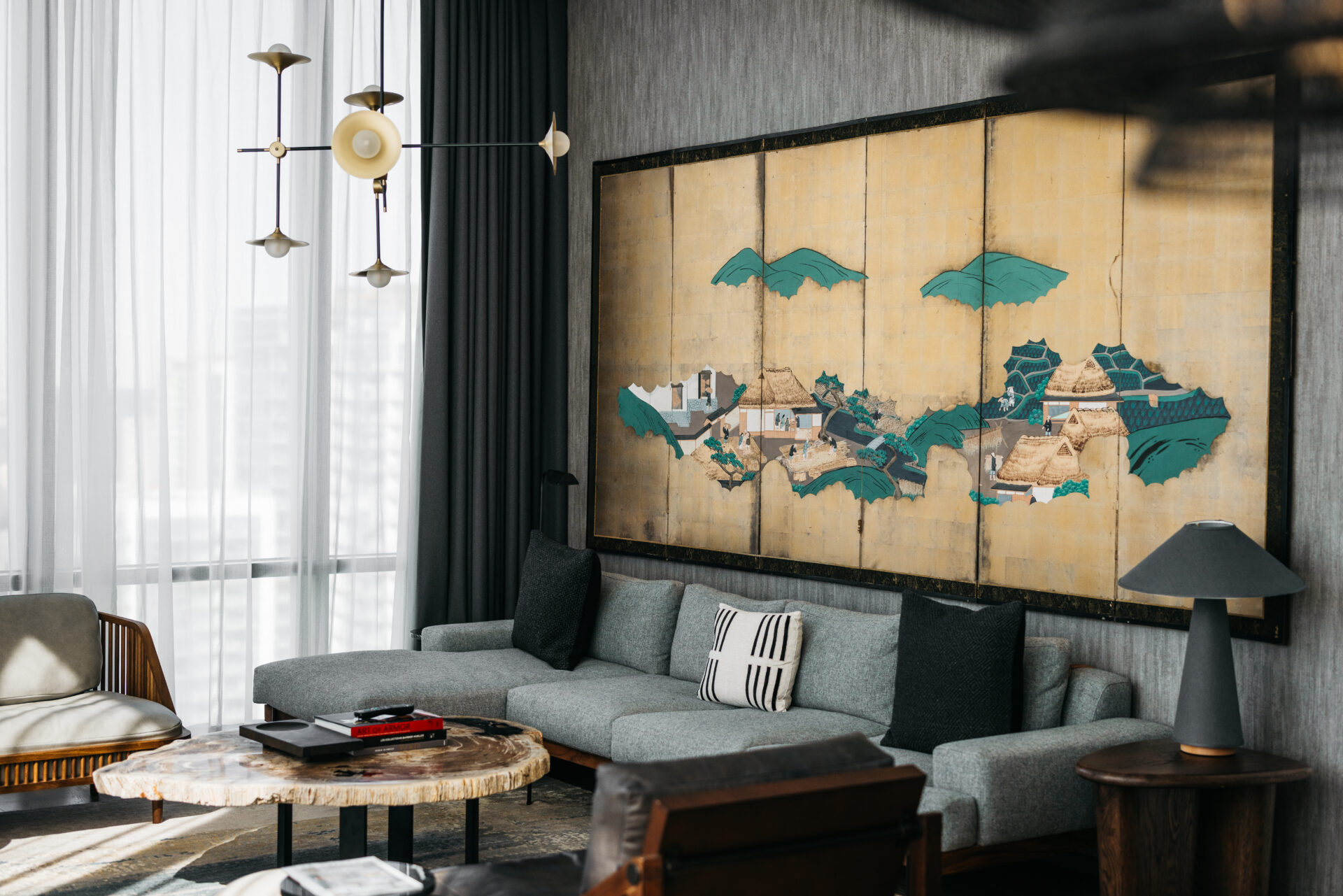 Hotel Swexan interior with gold panelled painting along back wall in grey lounge area, from The Leading Hotels of the World new book