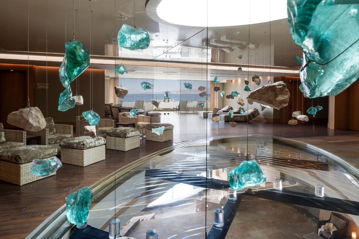 Crystals lit by natural light hang in the Six Senses Spa | Image credits: Elounda Collection