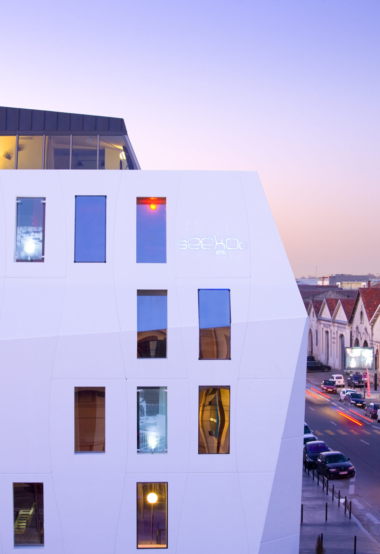 Shot of Seeko'o Hotel in Bordeaux during sunset. Building facade is Corian cladding creating a smooth white outer