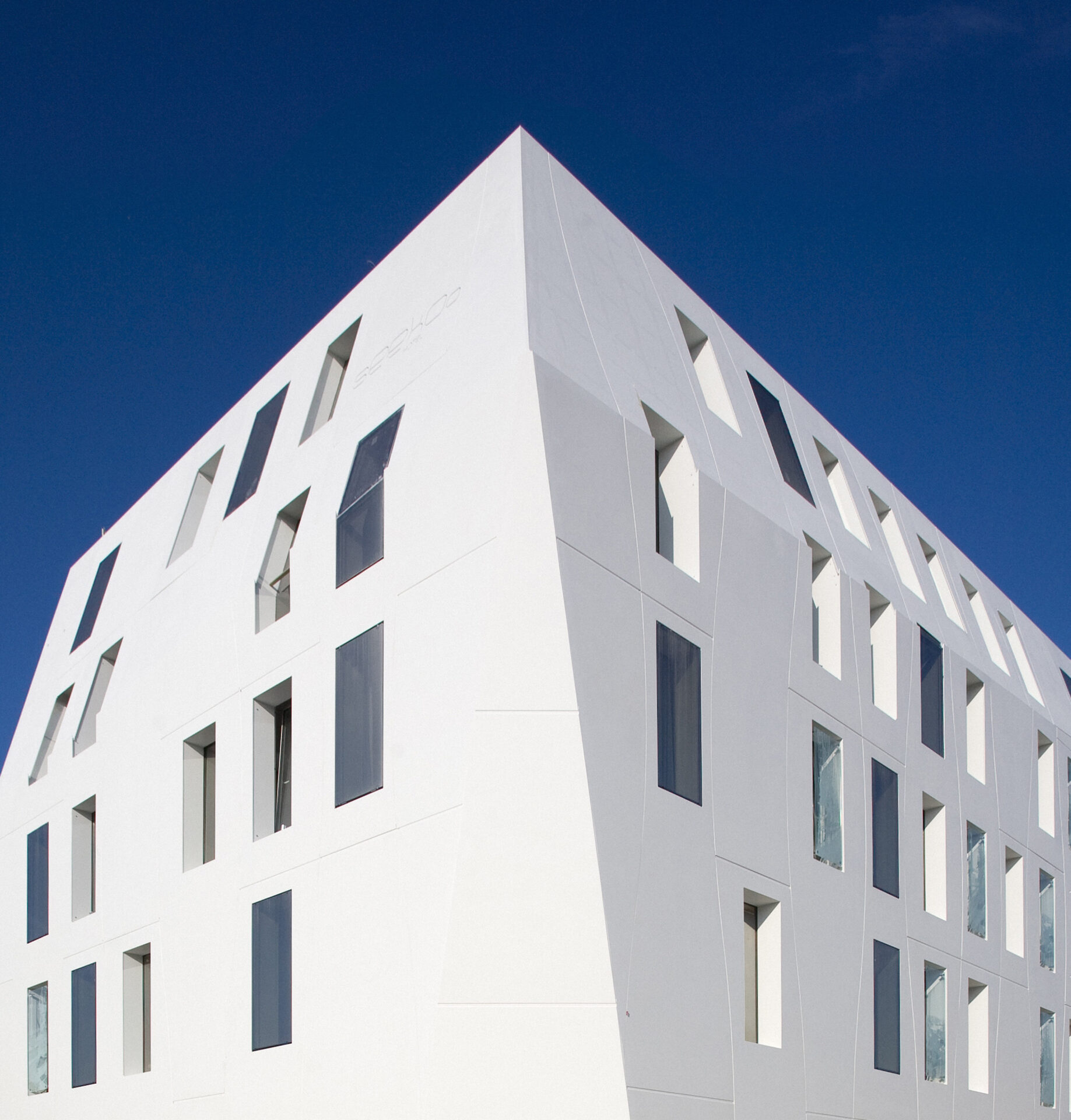 Shot of Seeko'o Hotel in Bordeaux during sunset. Building facade is Corian cladding creating a smooth white outer
