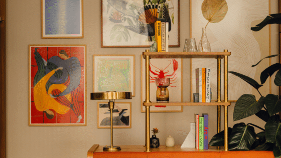 Gallery wall with brass pipe shelving in Communal space at Branch members club, by Holloway Li