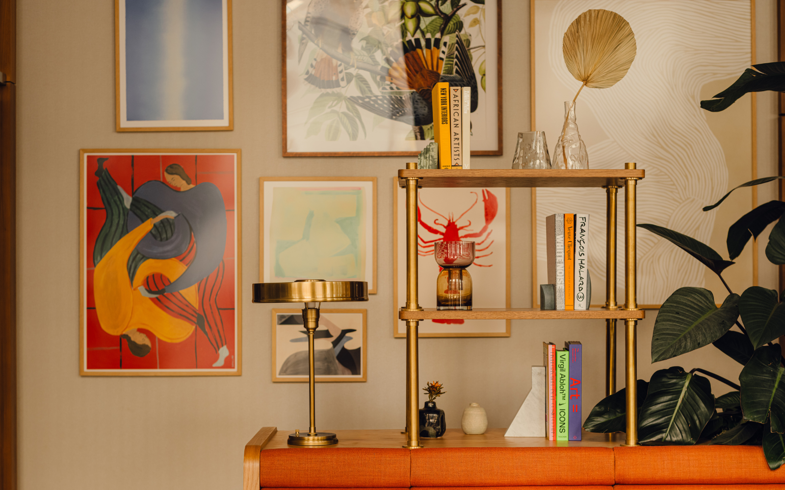 Gallery wall with brass pipe shelving in Communal space at Branch members club, by Holloway Li