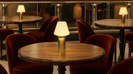 Bubble cordless lighting from Northern Lights, set on round wooden table with burgundy velvet seats surrounding