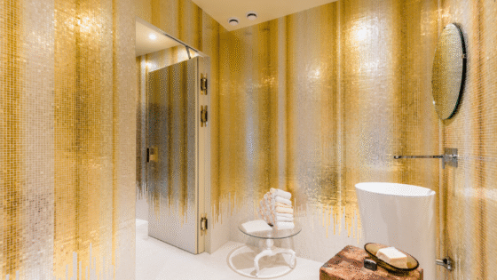 Gold and silver mosaic in bathroom. Gold drips down towards floor. By Orsoni mosaics