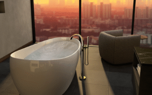 Bathroom by TOTO, with floatation tub overlooking cityscape through floor to ceiling glass window