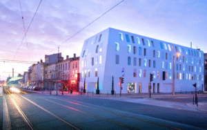 Shot of Seeko'o Hotel in Bordeaux during sunset. Building facade is Corian cladding creating a smooth white outer