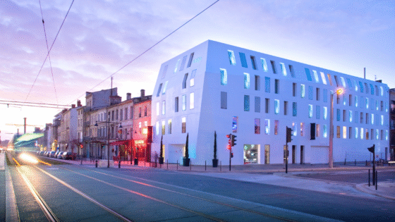 Shot of Seeko'o Hotel in Bordeaux during sunset. Building facade is Corian cladding creating a smooth white outer