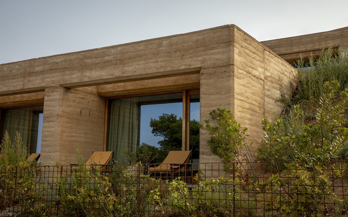 square concrete and stone structure in natural garden at Mylos Hotel