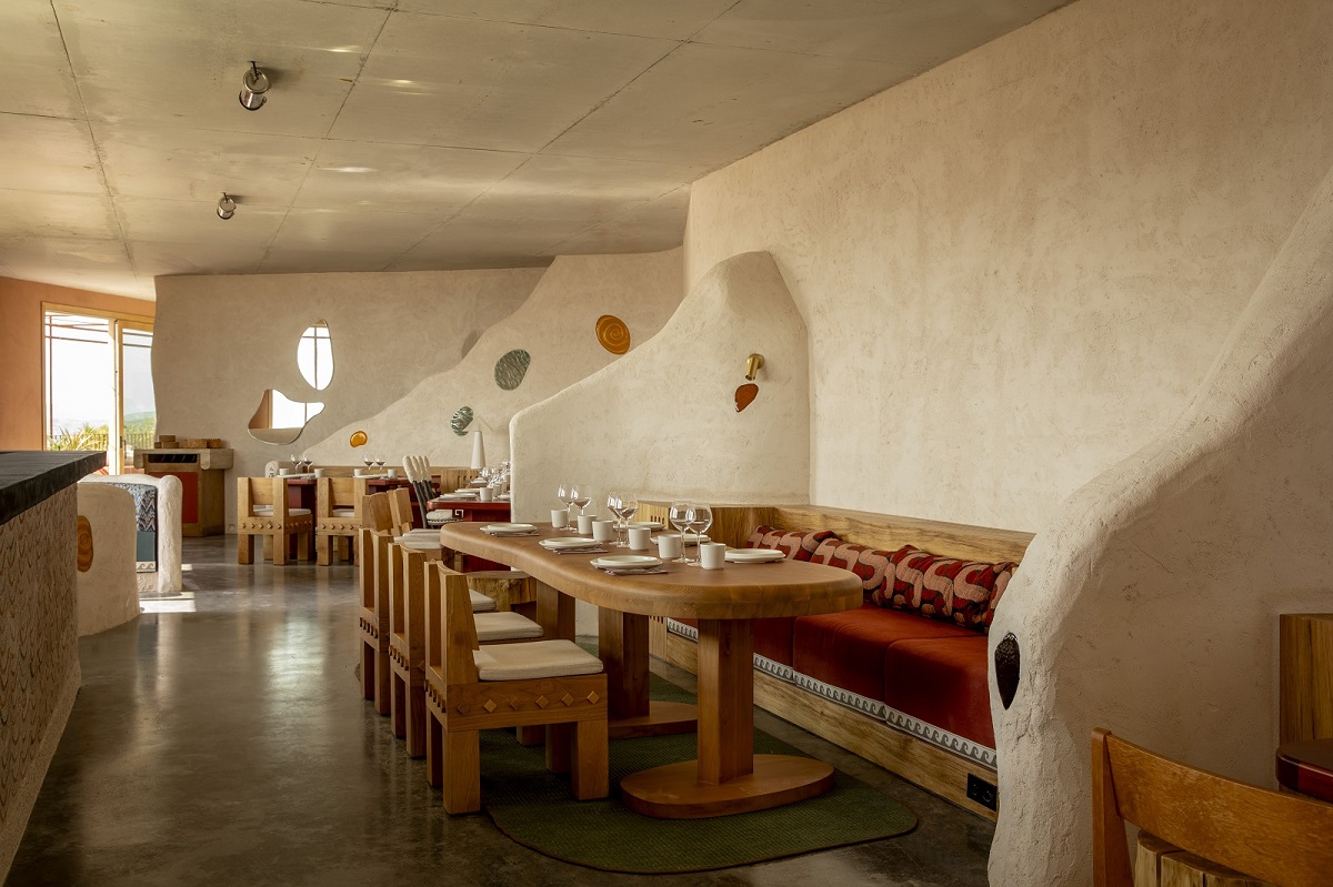 organic shapes and accents of olive green and terracotta in the restaurant design in Mylos hotel Corsica