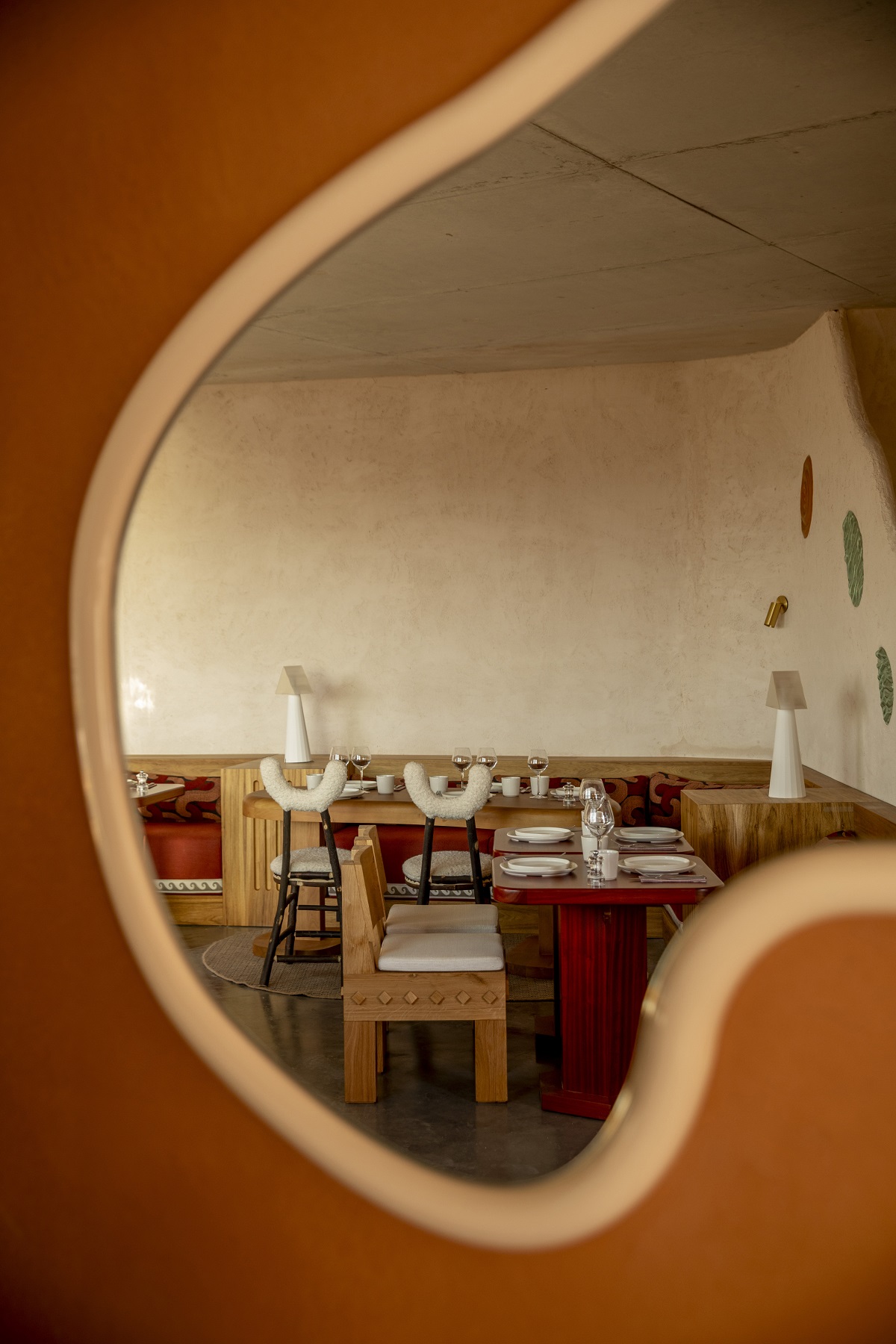 organic shaped mirror with restaurant design at Mylos hotel in reflection