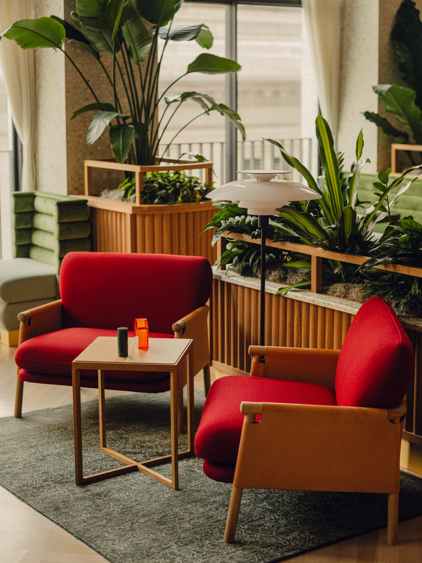 Photography Credits: PION Studio Lounge chair pairing in-front of custom planting design by Holloway Li. The fluted timber detailing is designed to recall the rhythmic spines of stacked books