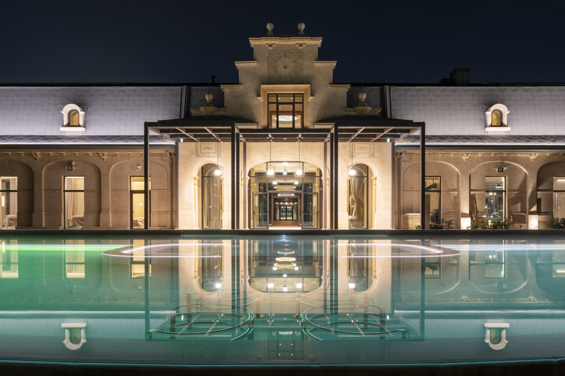 Exterior of the De Montel: Terme di Milano, at night with uplighting above water