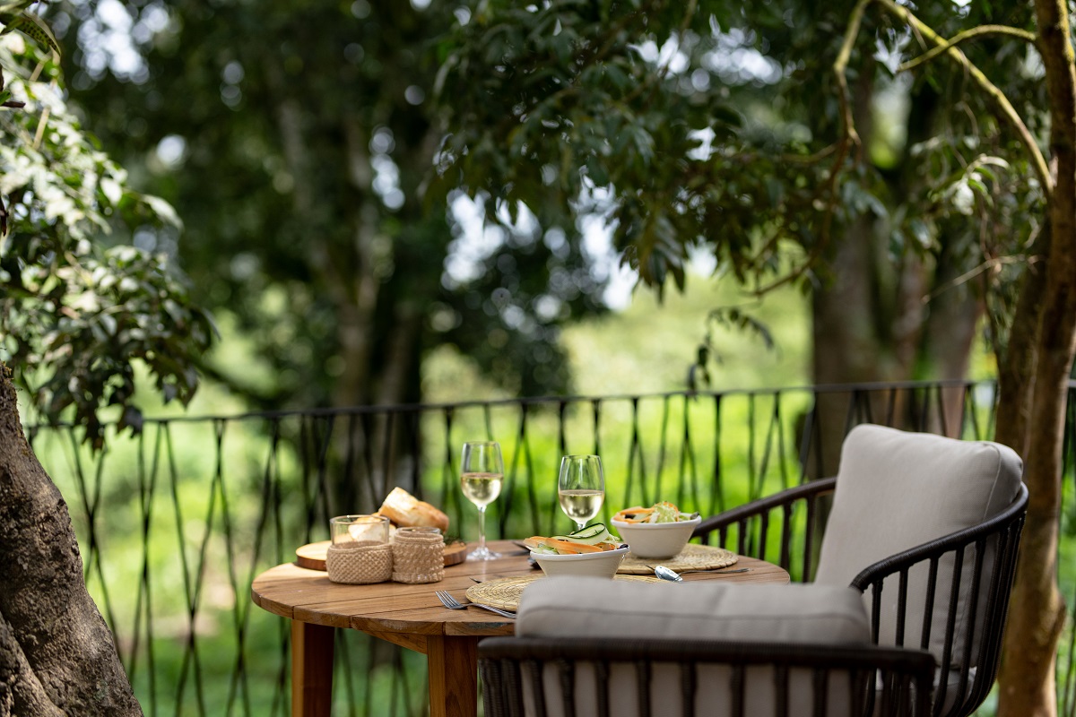 dining table and chairs on terrace overlooking the treetops at Ngorongoro crater