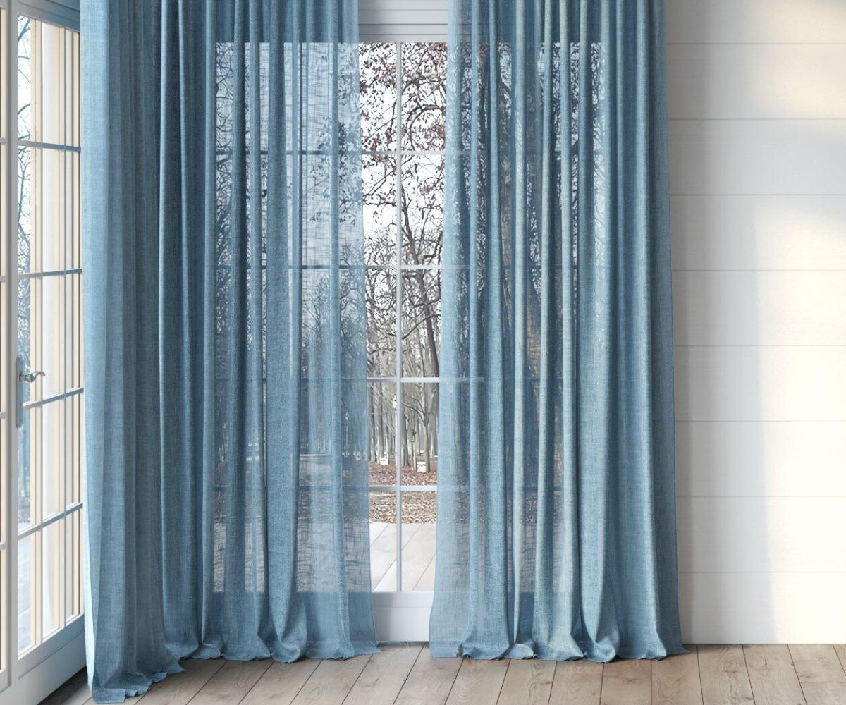 light blue sheer curtains in floor to ceiling window