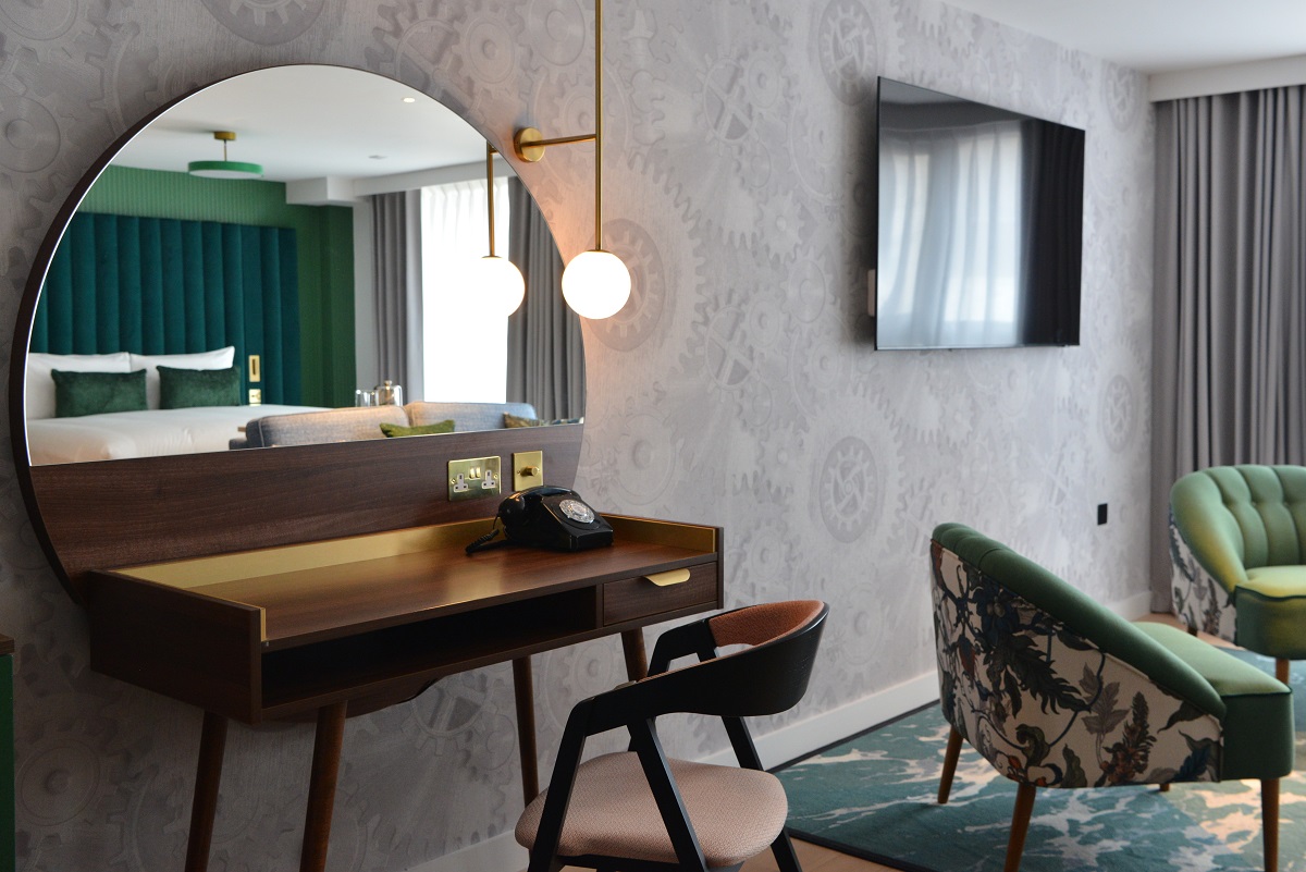 hotel Indigo guestroom with wallcovering from Newmor referencing clocks