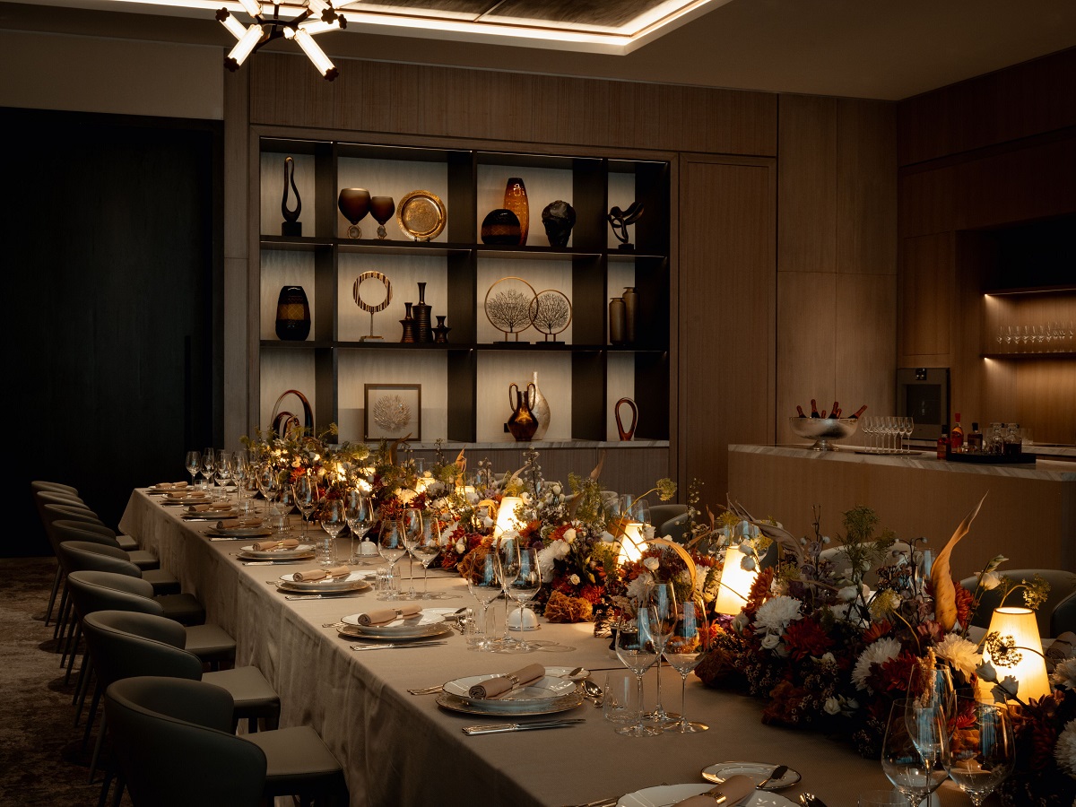 long dining table in rosewood doha set with floral arrangement for candleit dinner with