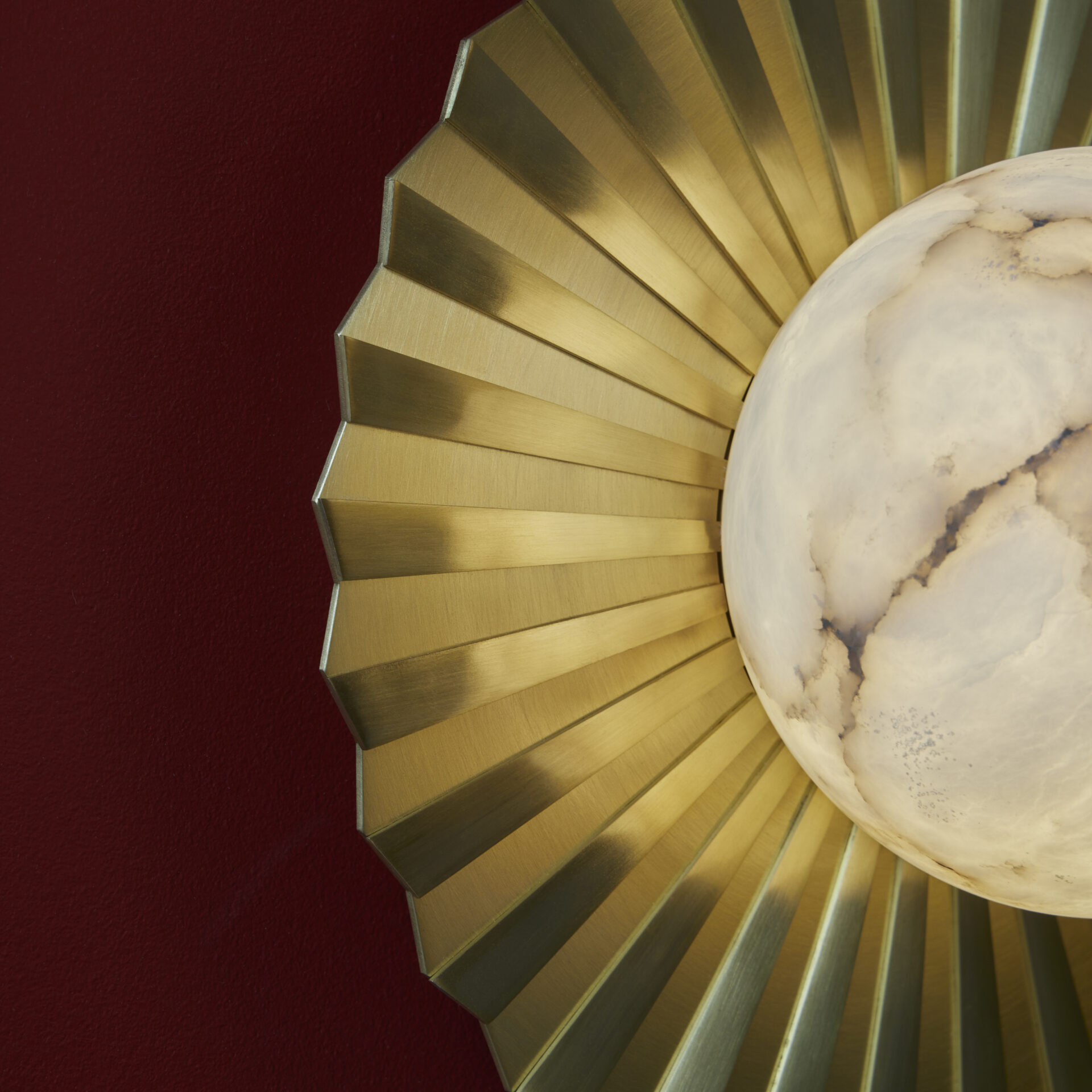 Vistal light from Northern Lights, an alabaster globe mounted on a fluted brass plate