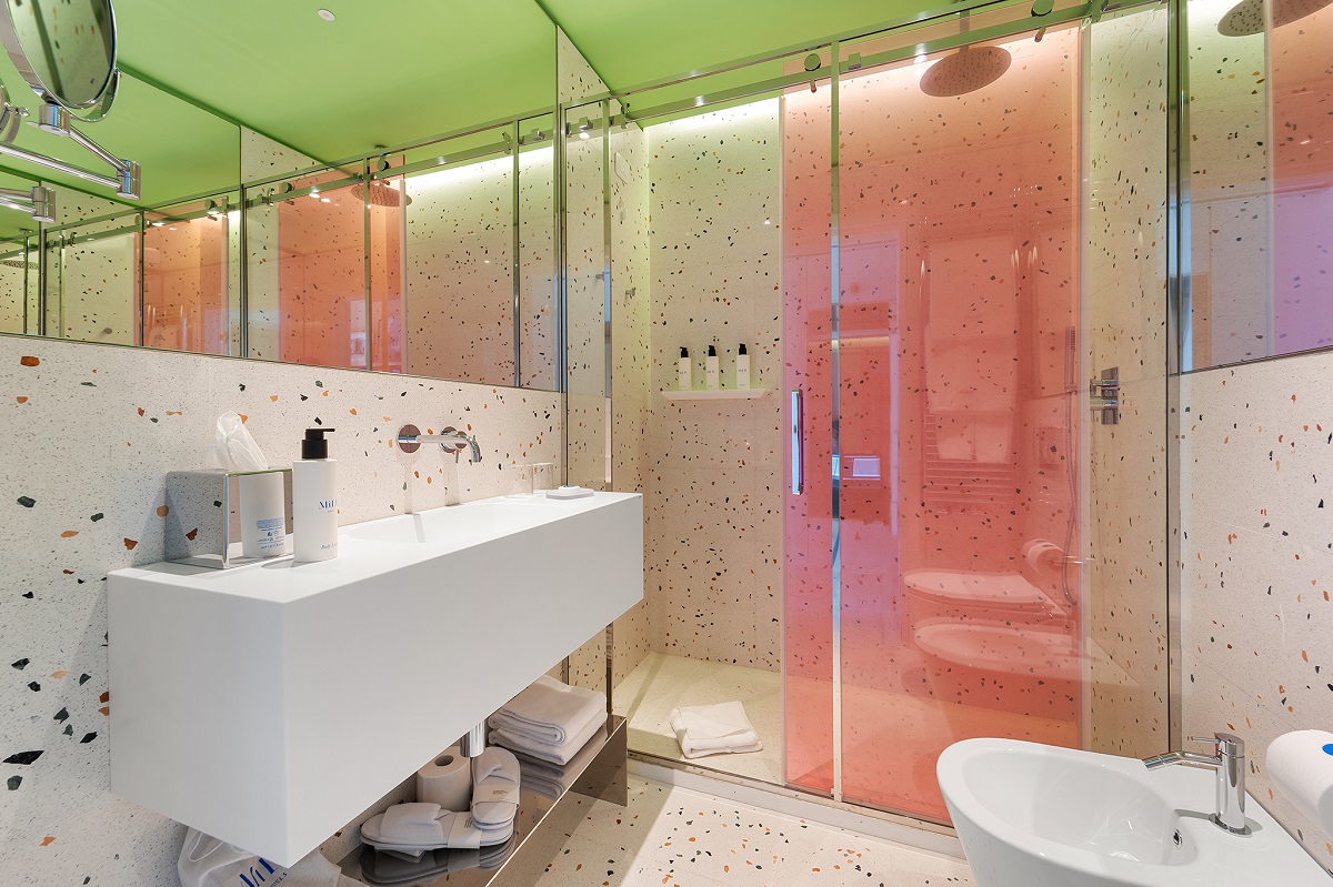 pink and green accents in bathroom with terrazzo surfaces