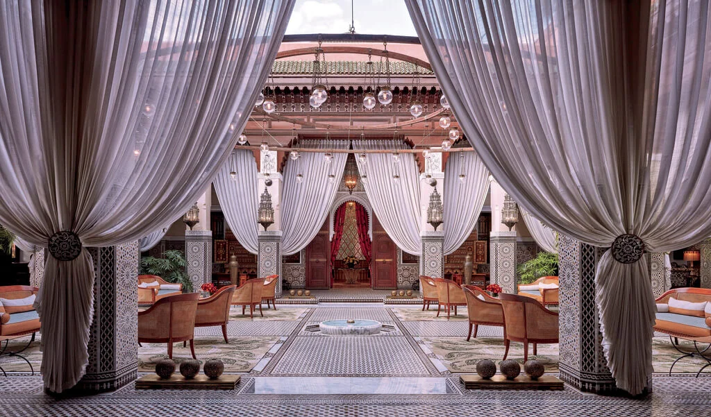 Public area in Royal Mansour Marrakech hotel, lots of sheer curtains draped around the space that has lots of light from glass ceiling