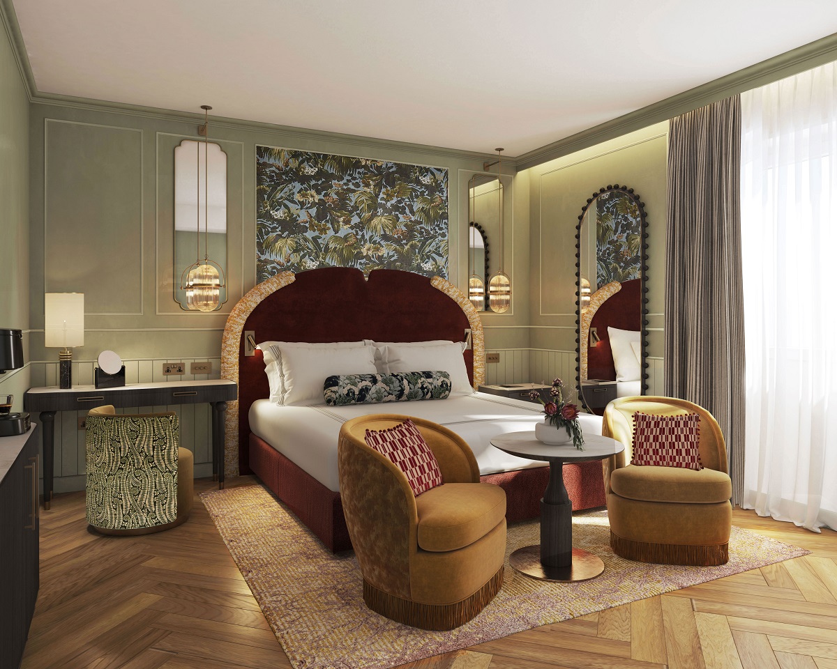 guestroom in Relais San Clemente with 2 chairs and table in front of a double bed