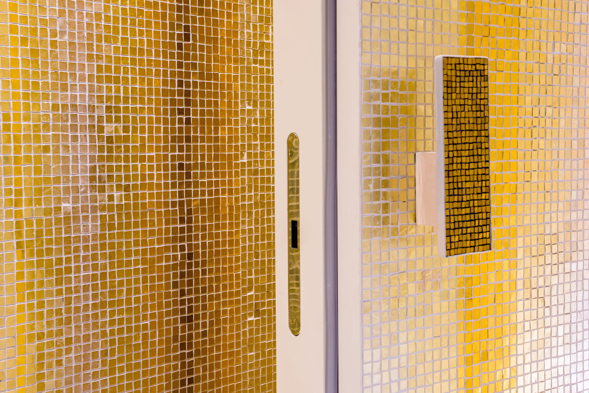 Gold and silver mosaic in bathroom. Gold drips down towards floor. By Orsoni mosaics