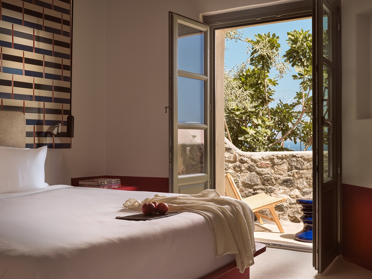 Contemporary interiors with whitewashed walls and soft red pops of colour in Domes Neema Maison Finikia