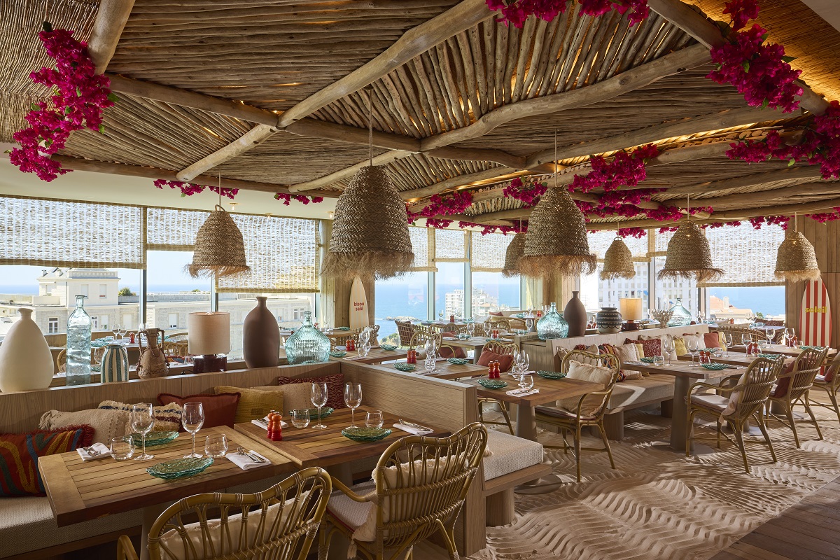 natural colours of clay and wood, bamboo, and wicker surfaces and lights in hotel restaurant