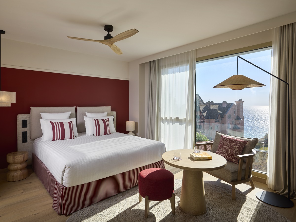 white bed linen with terracotta red accents and striped cushions