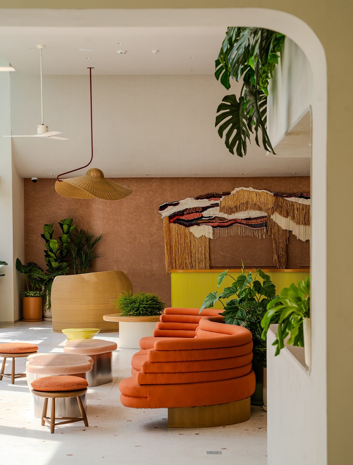 orange furniture and bright yellow desk in hotel lobby The Standard, Pattaya Na Jomtien