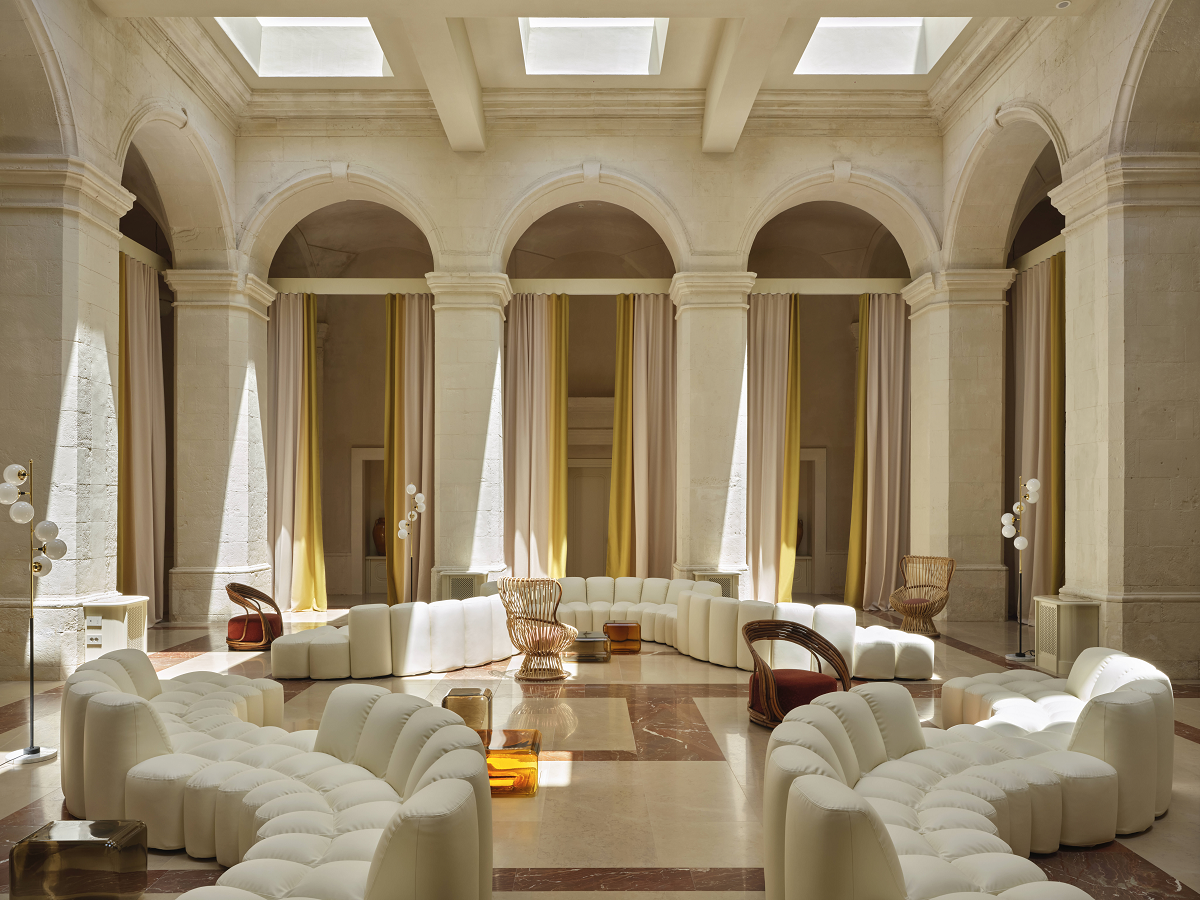 white contemporary curved sofas in restored 14th-century stone palazzo