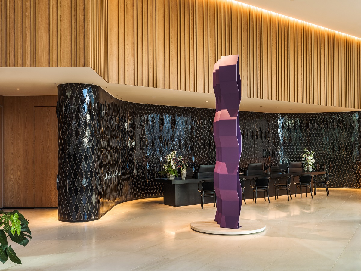 ME Lisbon hotel lobby with wood panelling and black tiled surfaces behind purple sculpture - ME by Meliá