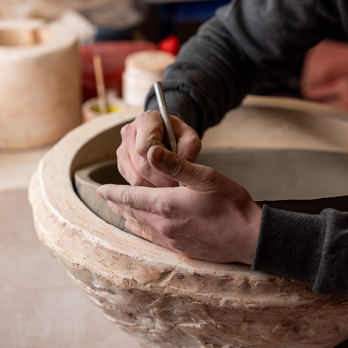 artisans hands working on a bespoke lighting project at Mullan Lighting