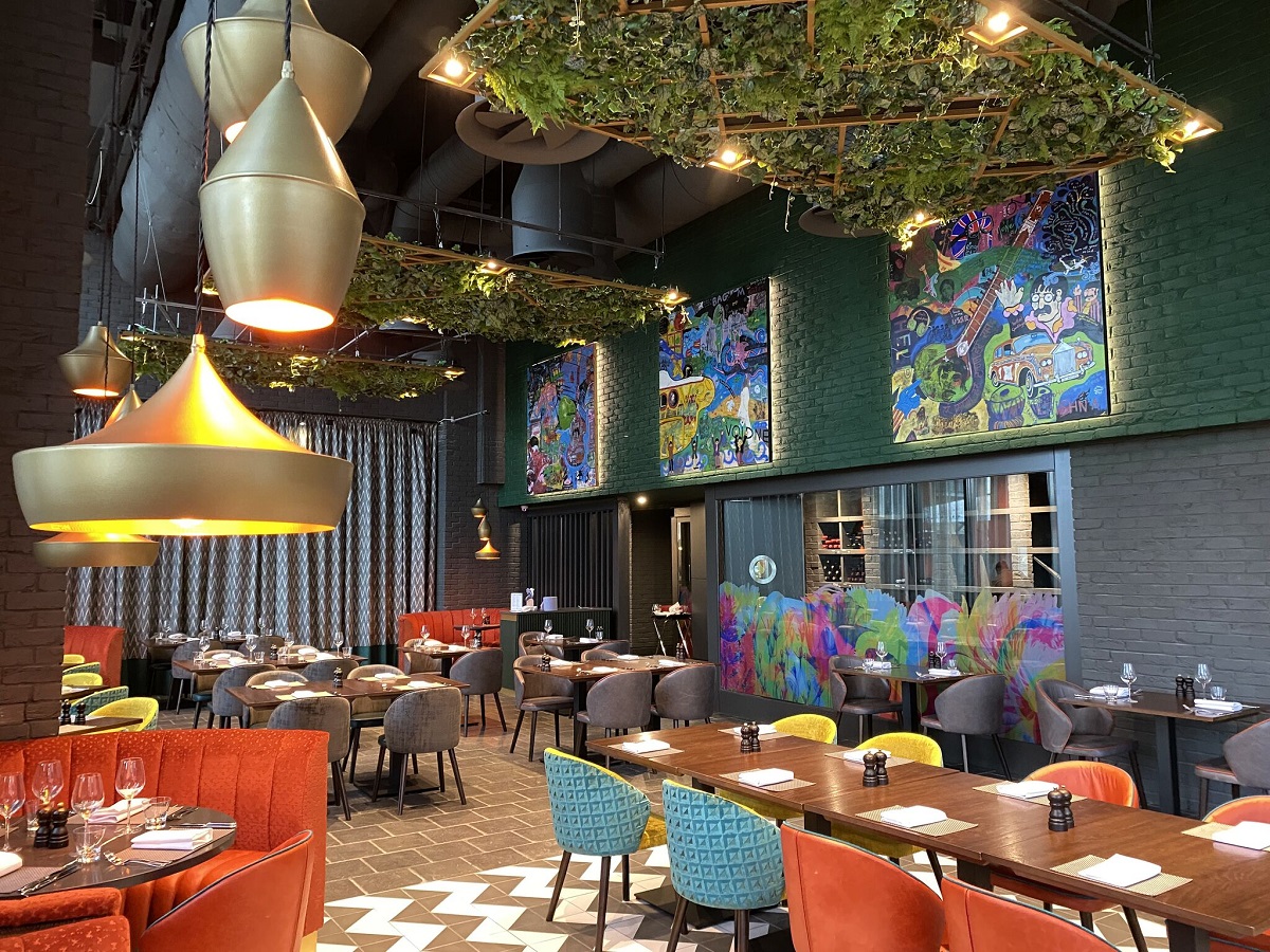 restaurant with colourful chairs and industrial lighting