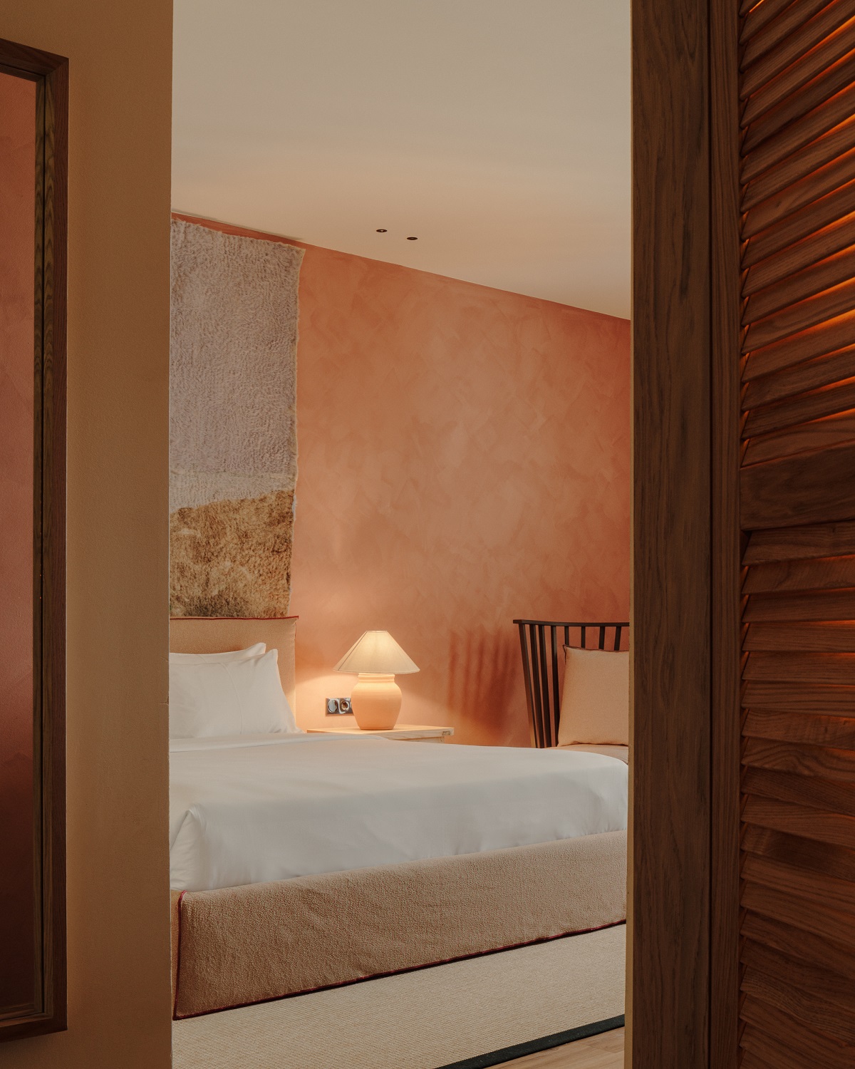 view through doorway into guestroom with terracotta colour accents