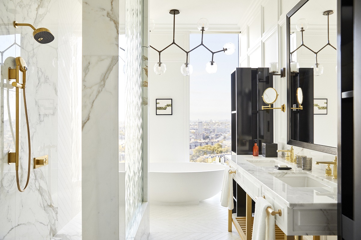 ambassador suite bathroom in park hyatt london with soaking tub, statement lighting and london view