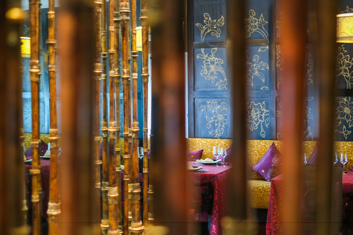 view through bamboo screen into restaurant in Pemako Hotels Bhutan