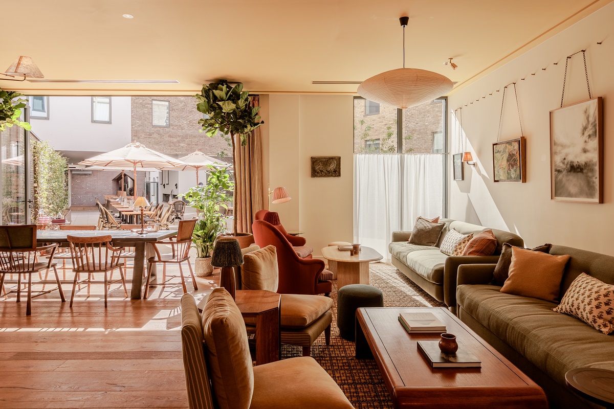 lobby and restaurant seating leading into courtyard in Wilde Cambridge
