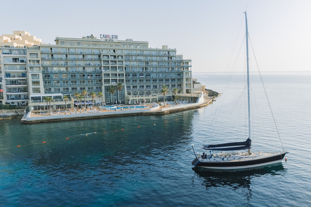 view from the sea with yacht in foreground and Cavalieri Art Hotel in background