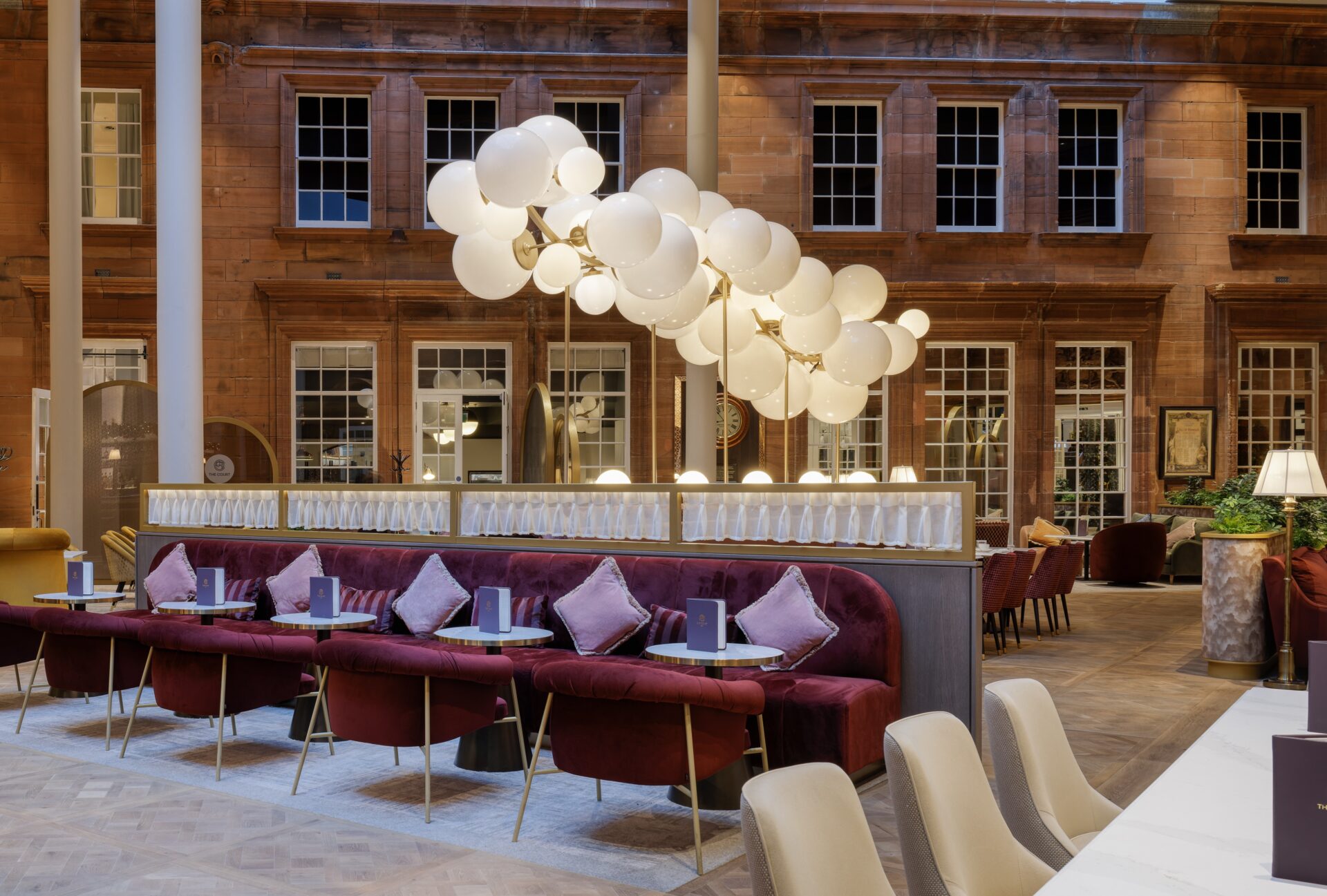 Fifty-eight individually assembled opal acrylic globes, in graduated sizes, are precisely arranged along a sweeping 4-metre-high, 7-metre-long gold metal spine in the centre of the Caledonian Edinburgh hotel restaurant
