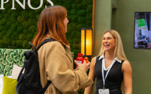 Two women in conversation and laughing at the Independent Hotel Show 2025