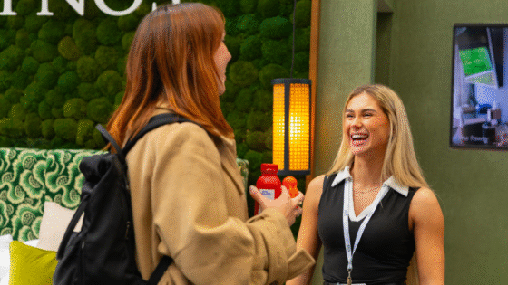 Two women in conversation and laughing at the Independent Hotel Show 2025