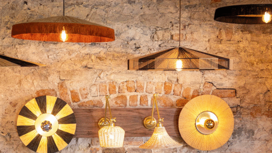 Selection of Mullan lighting creations hung on bare brick wall