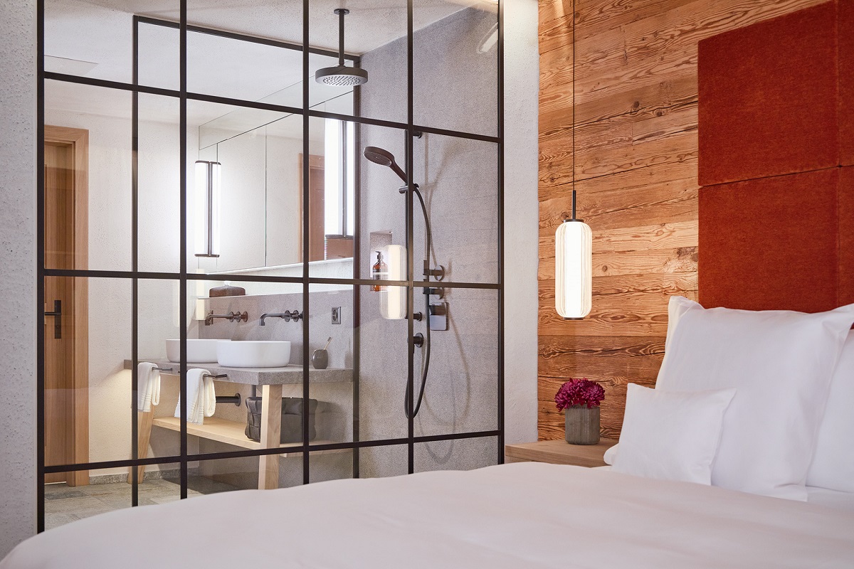 view from bedroom into bathroom through glass divide