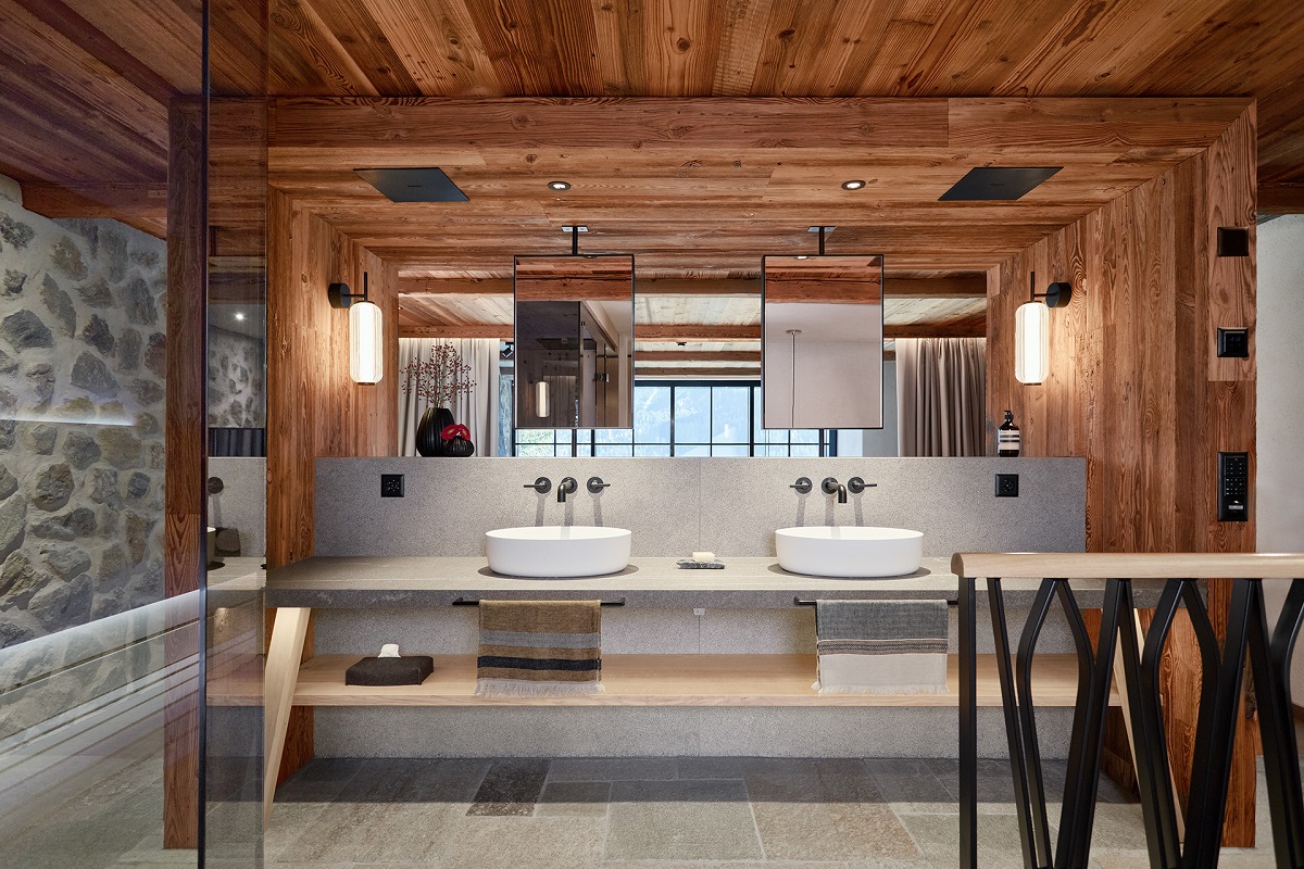 wooden beams, wood ceiling, stone walls in bathroom with double basin vanity